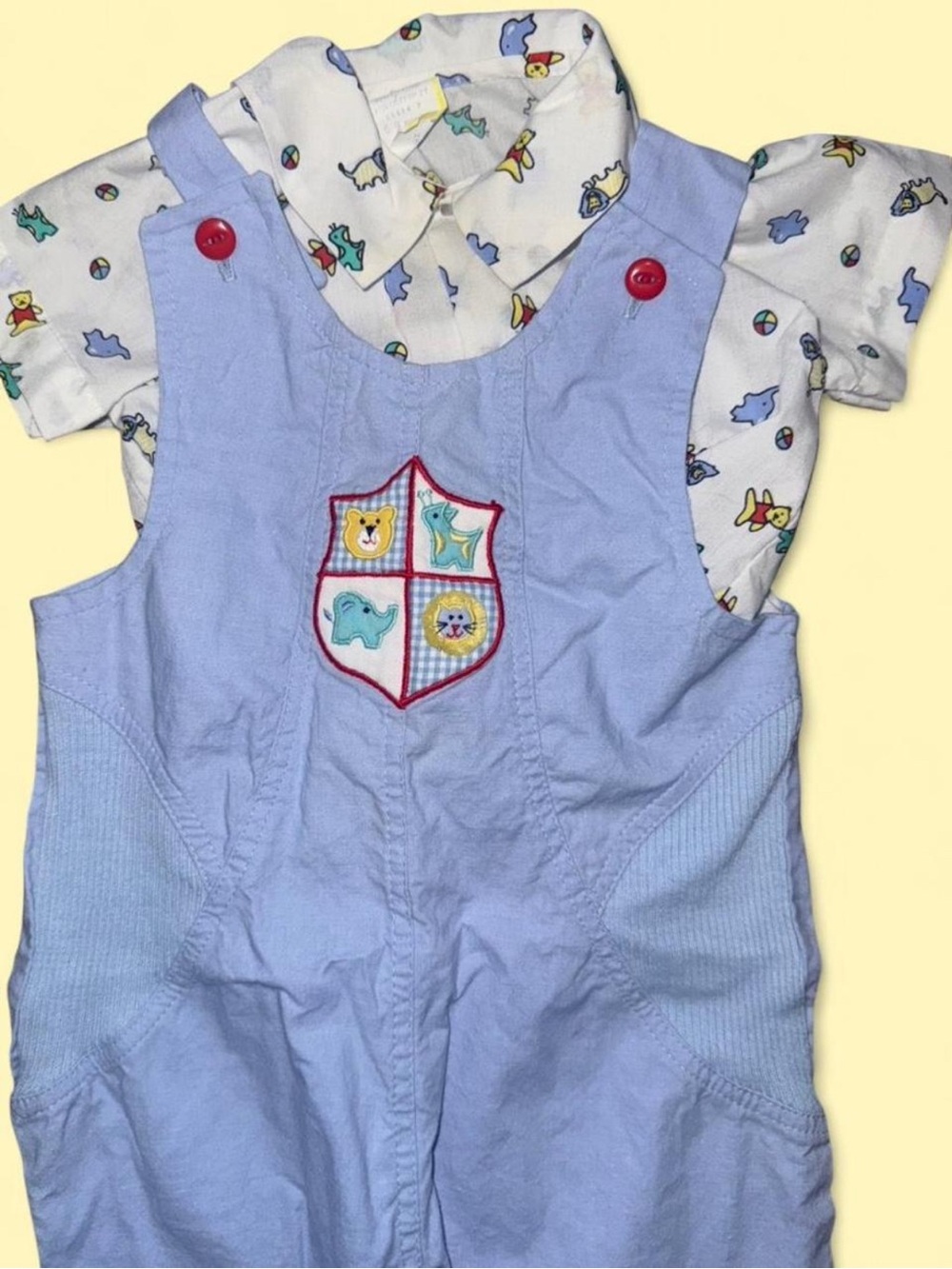 Vintage baby overalls with animal print.